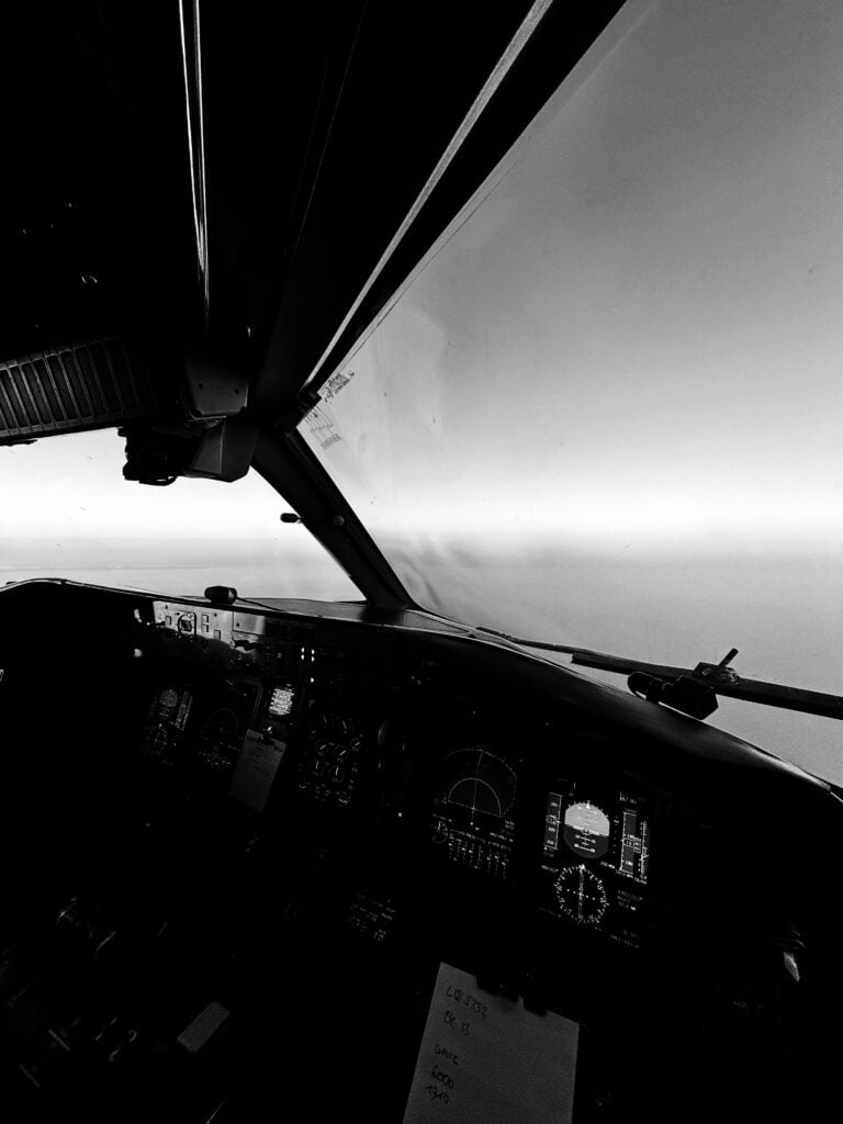 A black and white image of a Dash 8 -400 Cockpit